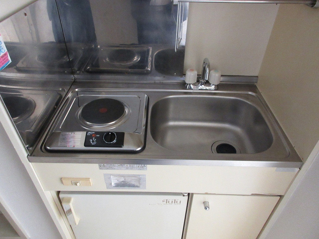 With electric stove and mini-refrigerator